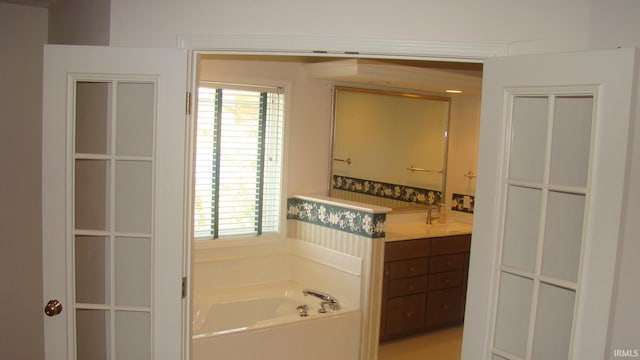 full bathroom with vanity and a garden tub