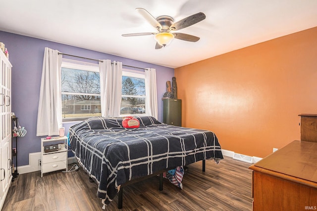 bedroom featuring dark wood finished floors, visible vents, ceiling fan, and baseboards