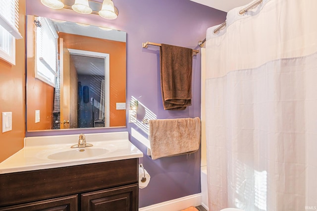 bathroom with shower / tub combo with curtain and vanity