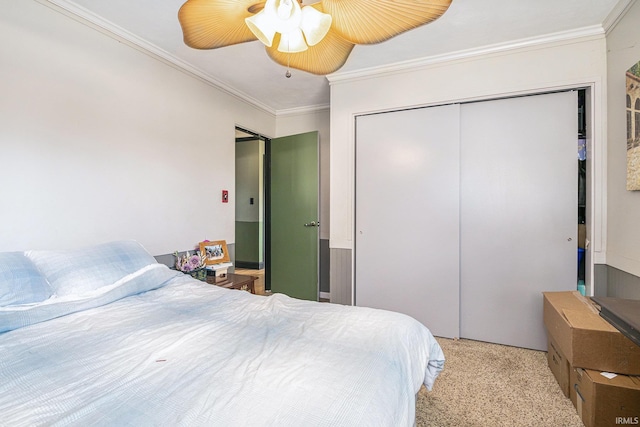 bedroom with a closet, a ceiling fan, and crown molding