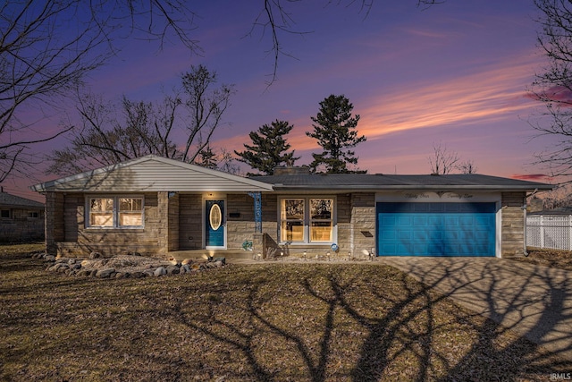 view of front of property with a garage, stone siding, driveway, and fence