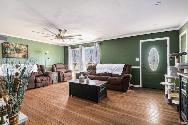 living room featuring hardwood / wood-style flooring, a ceiling fan, and ornamental molding