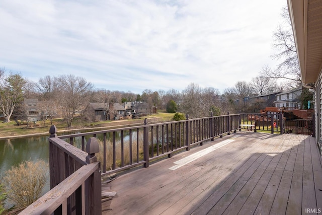 wooden deck with a residential view and a water view