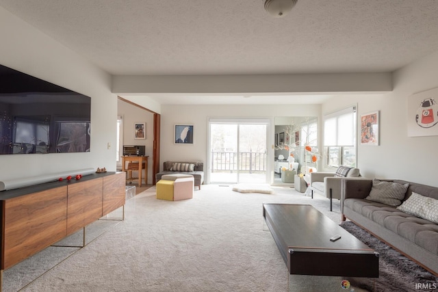 carpeted living room featuring a textured ceiling