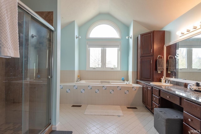 bathroom featuring tile patterned floors, a healthy amount of sunlight, and a stall shower