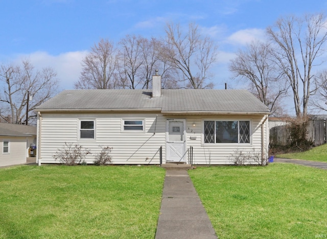 single story home featuring a front lawn, fence, and a chimney