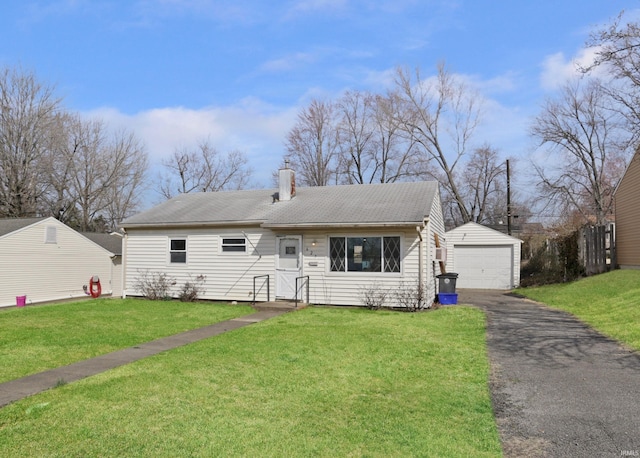 view of front of house with a garage, a front lawn, an outdoor structure, and a chimney