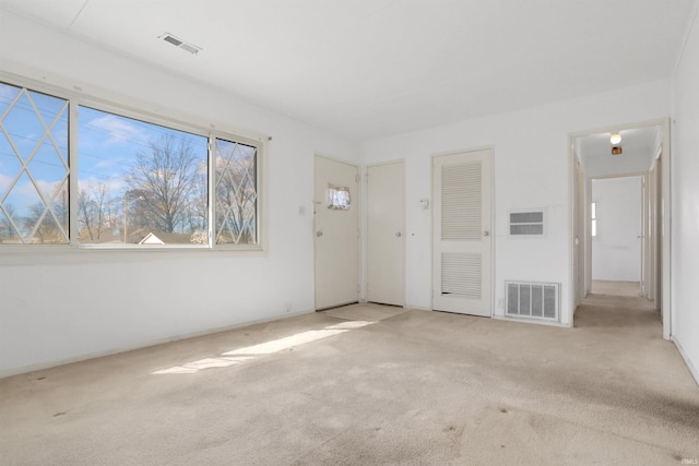 unfurnished living room with carpet flooring and visible vents