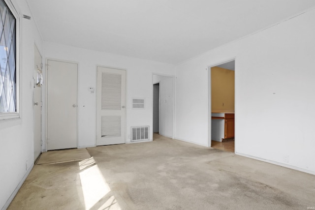 unfurnished room featuring light carpet and visible vents