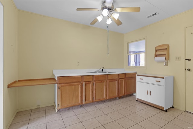 kitchen featuring visible vents, a ceiling fan, a sink, light countertops, and light tile patterned floors