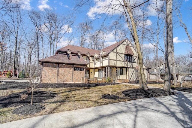 view of front of house featuring stucco siding and a shingled roof