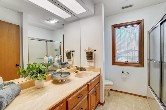 full bathroom with vanity, a shower with shower door, baseboards, visible vents, and toilet