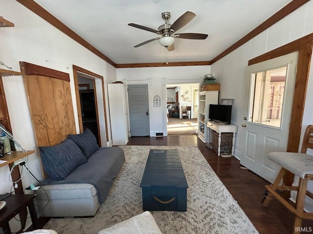 living area with dark wood-style floors, ceiling fan, and crown molding