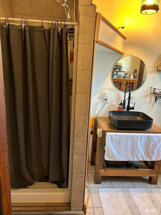 bathroom featuring vanity and a shower stall