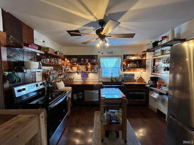 kitchen with a sink, open shelves, dark wood-type flooring, and stainless steel appliances