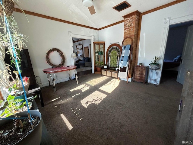 interior space featuring carpet floors, ceiling fan, crown molding, and vaulted ceiling