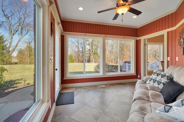 sunroom / solarium with visible vents and a ceiling fan