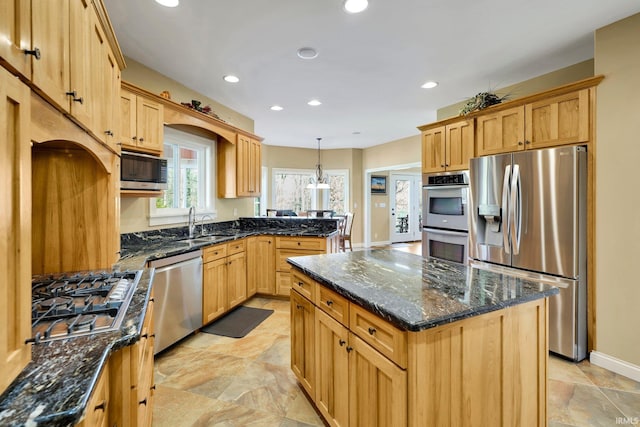 kitchen with a center island, recessed lighting, stainless steel appliances, and dark stone countertops