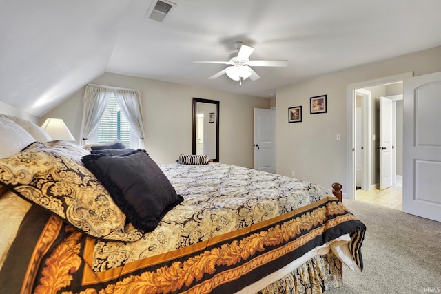 bedroom with visible vents, light tile patterned flooring, ceiling fan, vaulted ceiling, and light carpet