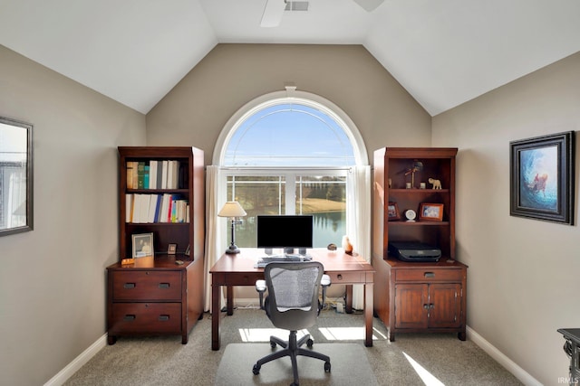 carpeted home office featuring lofted ceiling, visible vents, and baseboards