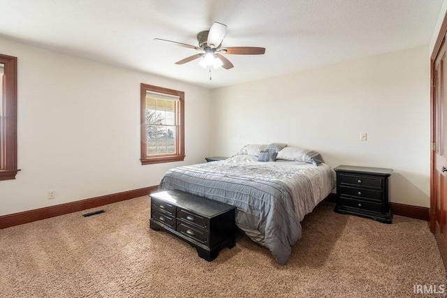 bedroom featuring baseboards, carpet floors, and a ceiling fan