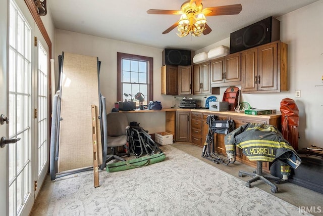 kitchen featuring brown cabinets, ceiling fan, and light countertops