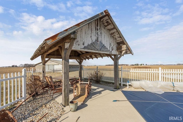 view of patio with a gazebo and fence