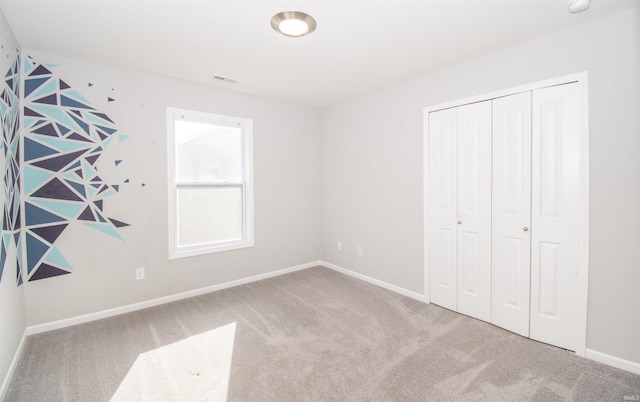 803 Knights Xing, Kendallville, IN 46755 - unfurnished bedroom with a closet, baseboards, visible vents, and carpet floors