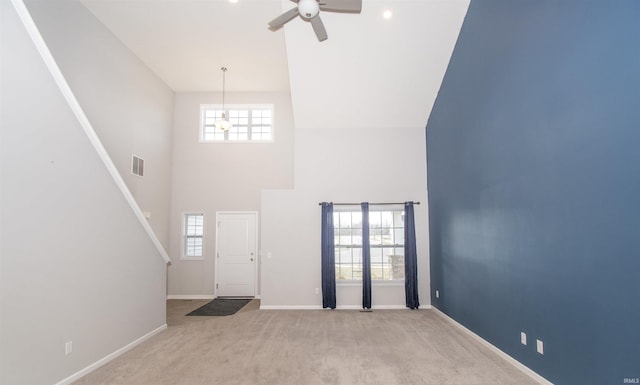 803 Knights Xing, Kendallville, IN 46755 - entrance foyer featuring visible vents, baseboards, carpet flooring, a high ceiling, and a ceiling fan