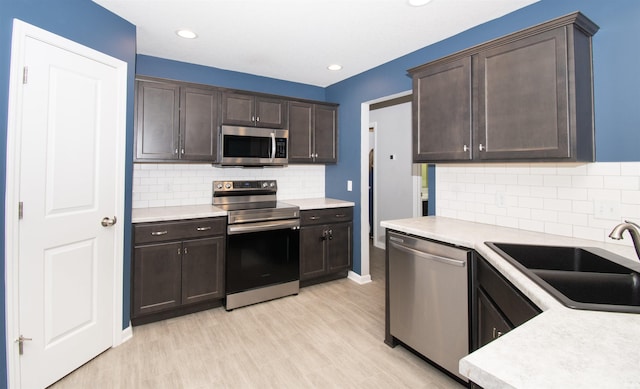 803 Knights Xing, Kendallville, IN 46755 - kitchen featuring a sink, appliances with stainless steel finishes, light countertops, and dark brown cabinets