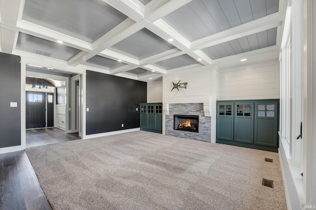 unfurnished living room with beamed ceiling, visible vents, and coffered ceiling