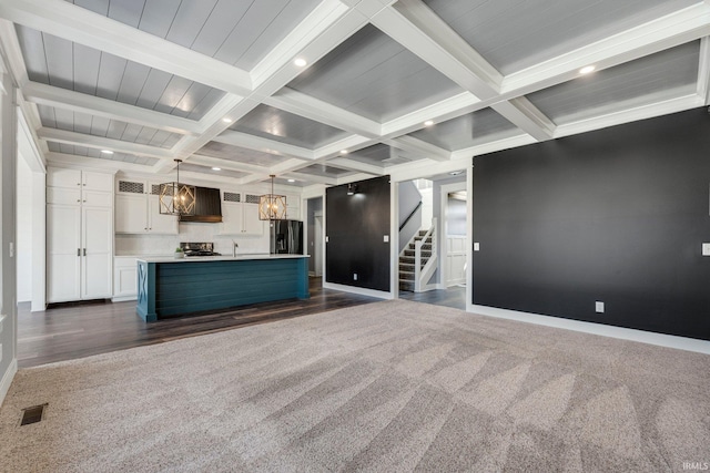 unfurnished living room featuring visible vents, coffered ceiling, recessed lighting, beamed ceiling, and dark carpet