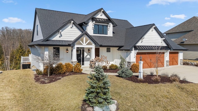 view of front of house featuring driveway, a shingled roof, board and batten siding, a front yard, and an attached garage