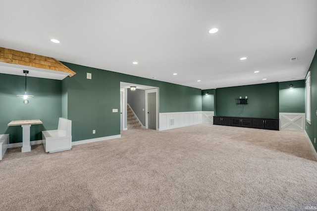 unfurnished living room with recessed lighting, stairs, and carpet floors