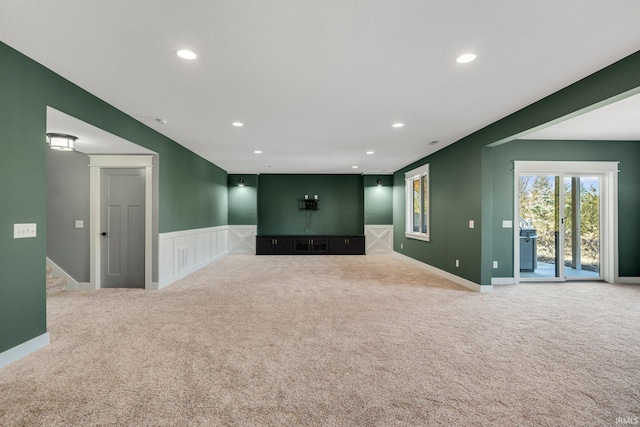 unfurnished living room featuring recessed lighting, baseboards, and carpet flooring