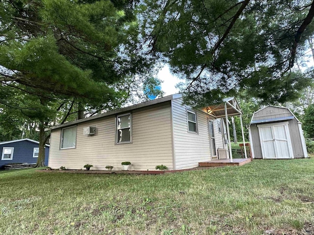 view of home's exterior featuring a lawn, a storage shed, and an outdoor structure