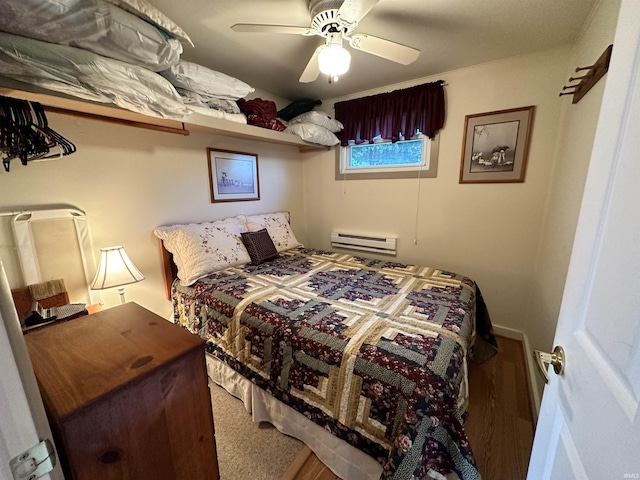 bedroom featuring a baseboard heating unit and a ceiling fan