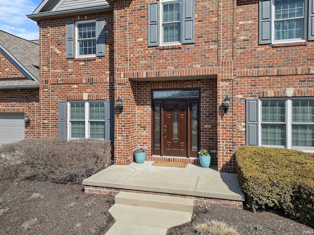 view of exterior entry with brick siding