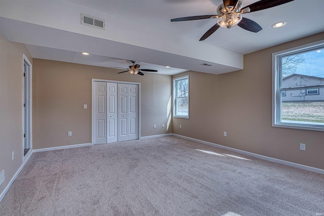 unfurnished bedroom featuring recessed lighting, visible vents, baseboards, and carpet