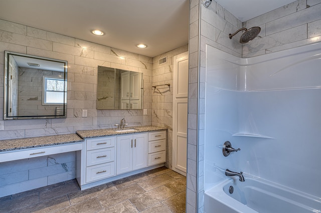 full bath featuring vanity, visible vents, recessed lighting, shower / tub combination, and tile walls