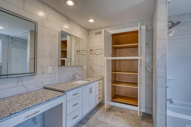 full bath featuring visible vents, tasteful backsplash, recessed lighting, tile walls, and vanity