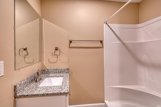 bathroom with vanity and a shower