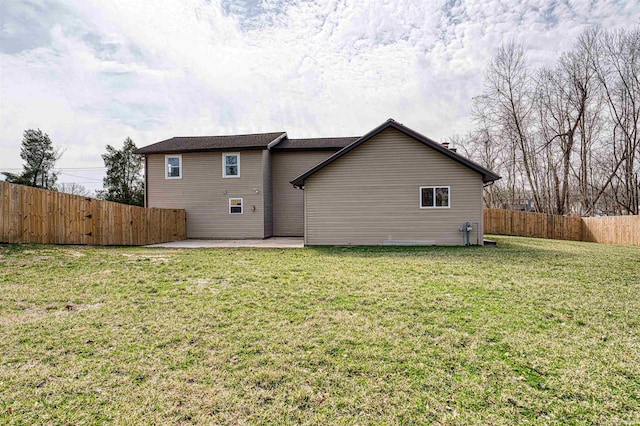 back of property featuring a patio, a lawn, and a fenced backyard