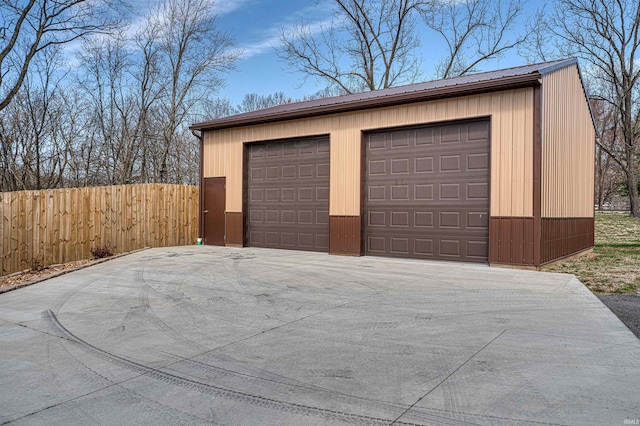 detached garage featuring fence