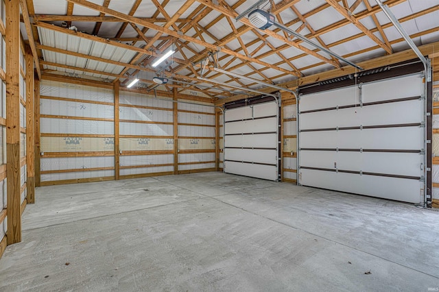 garage with a garage door opener and metal wall