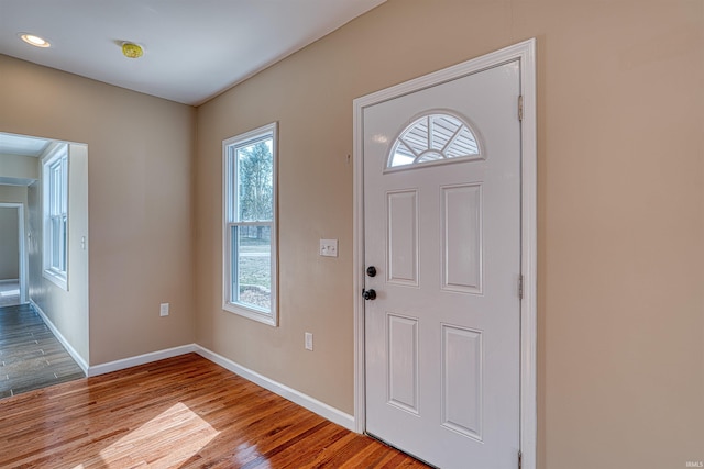 foyer with wood finished floors and baseboards