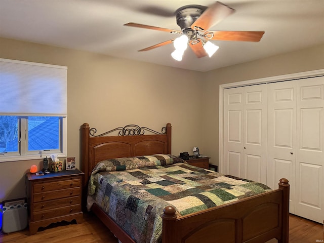 bedroom featuring a closet, wood finished floors, and a ceiling fan