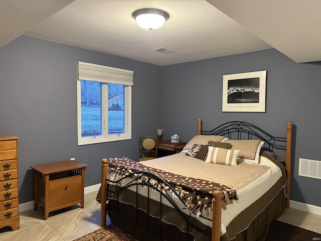 bedroom featuring baseboards and visible vents