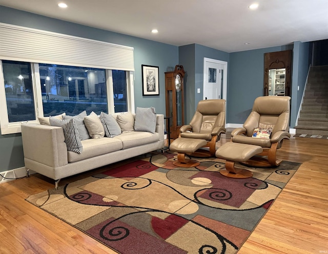 living area featuring recessed lighting, baseboards, and wood finished floors