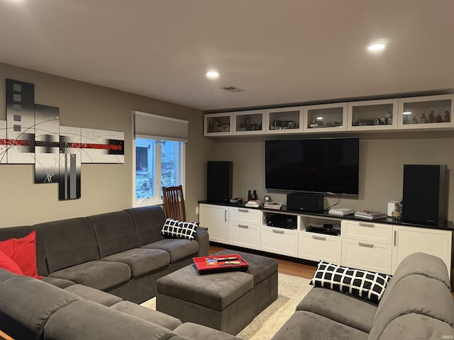 living room featuring visible vents, recessed lighting, and dark wood-type flooring